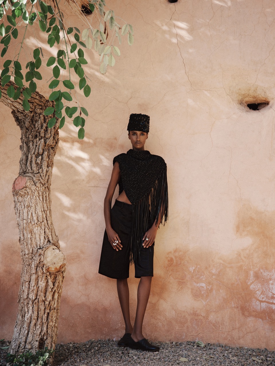 Bibi wears a Bode sequin-embellished cap ($345), Kallmeyer Solange fringe tunic ($2,915), The Row silk satin shorts ($2,275), AGMES synergy ring ($420), AGMES Turner ring ($500), AGMES Marta ring ($250) and Lemaire full-grain leather loafers ($755). Bibi Abdulkadir by Su Mustecaplioglu 1